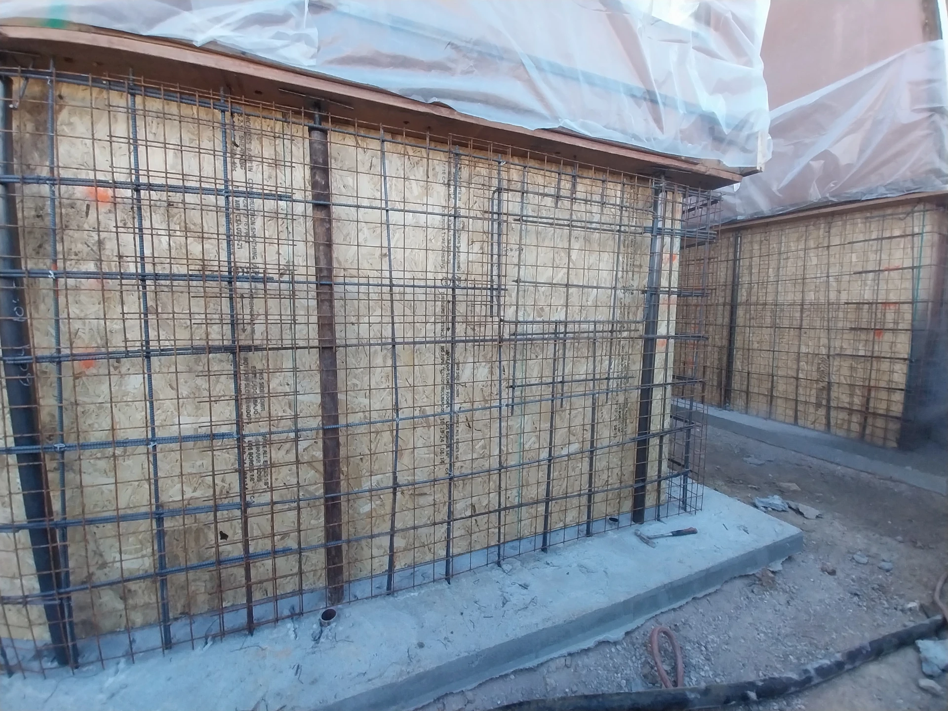 Reinforced rebar cage and plywood formwork ready for concrete wall pour