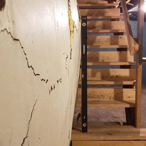 Bowing basement wall requiring wall anchor stabilization